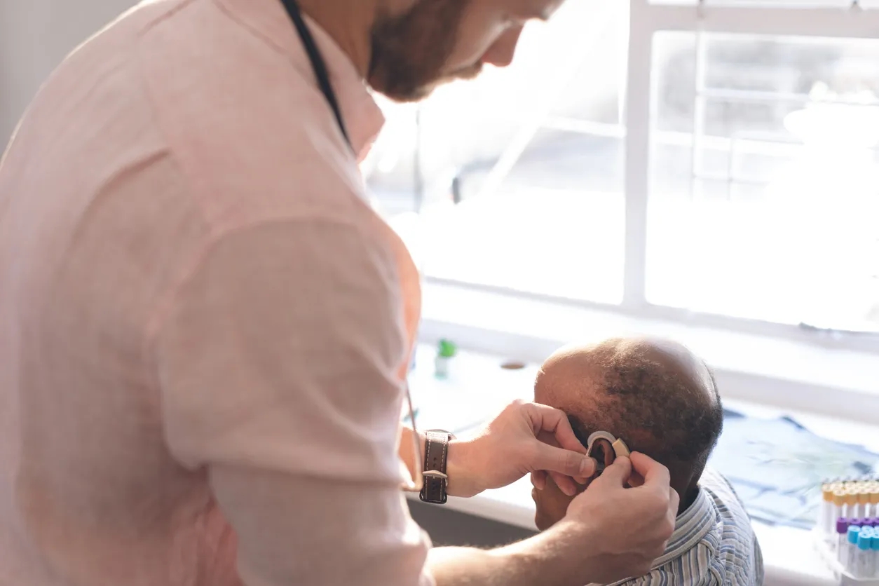 Man having a hearing aid fitted