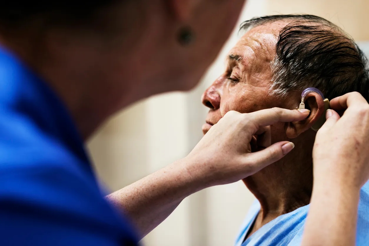 Man having a hearing aid fitted