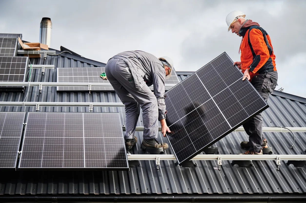Men fitting a solar panel