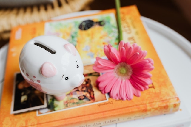 Piggy bank with a pink flower